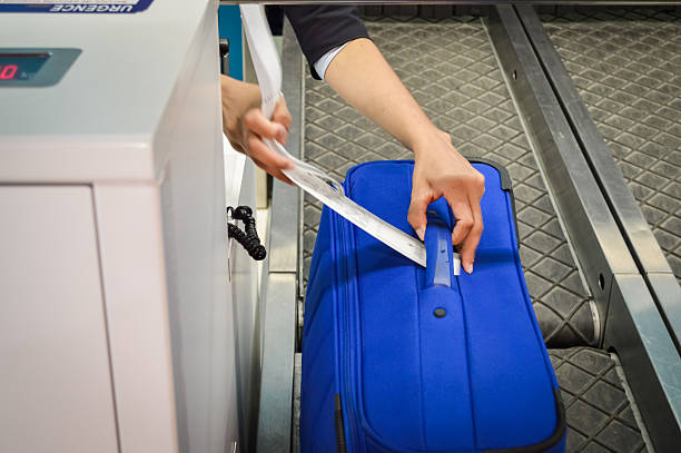 istock hands attaches a luggage tag to suitcase 540733010