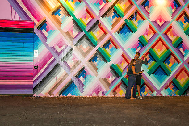 Couple taking a selfie with art murals at Wynwood Walls stock photo