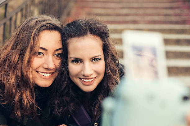 istock Girls taking selfie with instant camera 540734232