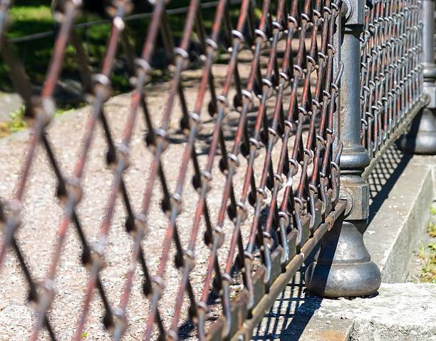 indistinct fragment of an old iron fence closeup in park in outdoor and a blank space