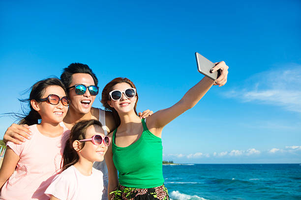istock happy family taking a selfie at the beach 540736658