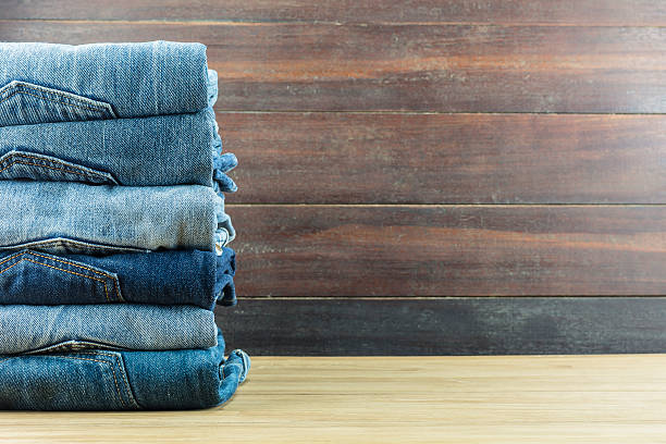 istock Jeans on a wooden background. 540740044