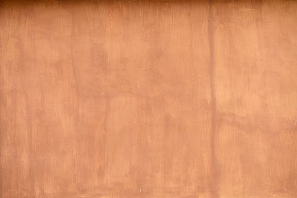 terracotta coloured stucco wall background stock photo