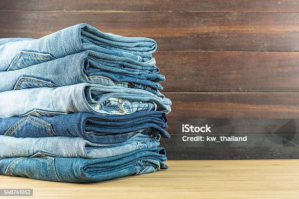 Jeans On A Wooden Background Stock Photo - Download Image Now - Clothing, Folded, Jeans