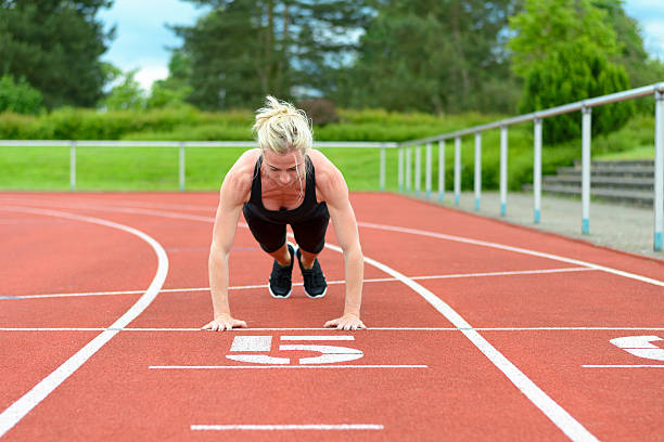 istock Single woman stretching calf muscles at race track 540743078