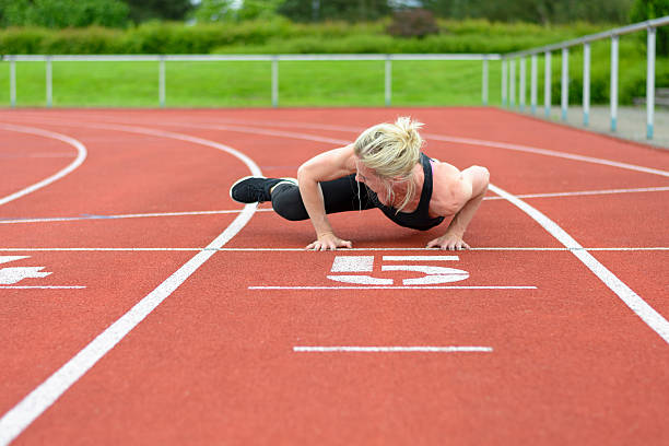 istock Athletic woman warming up hip muscles at track 540743162