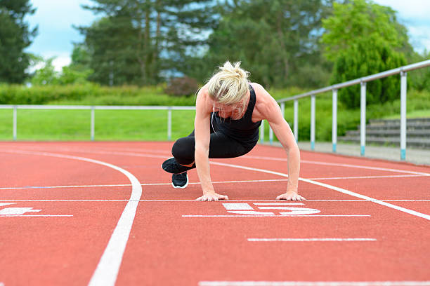 istock Athletic woman warming up hip muscles at track 540743212