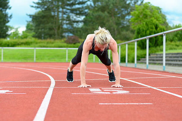 istock Single woman stretching calf muscles at race track 540743280