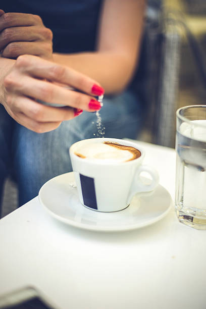 istock Female hand pours sugar into coffee 540743864