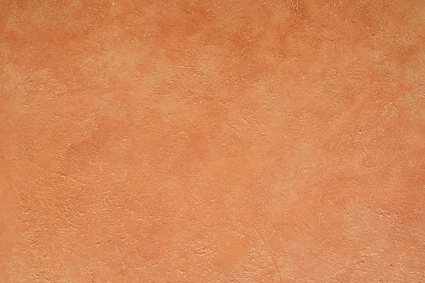 rustic textured terracotta coloured stucco wall background stock photo