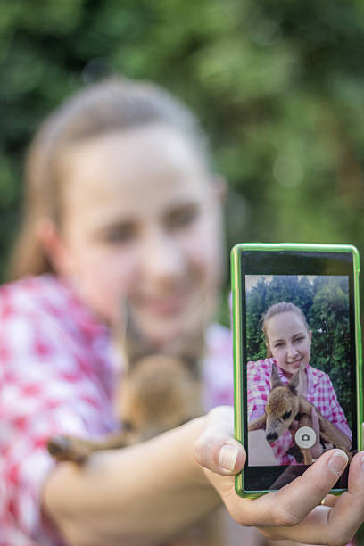 istock Young woman selfie with a litlle deer 540746538