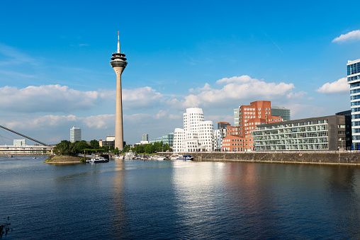 Düsseldorf's Media Harbor (Medienhafen) with Rheinturm tower and modern architecture.