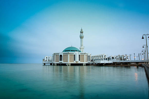 Al Rahma Mosque Floating is a modern mosque built on the edge of the beach, Corniche Jeddah in Saudi Mosque, and called officially Rahma Mosque name. This mosque is the most mosques in Jeddah visit, especially among Muslims in the East Asian pilgrims. The mosque was built a fantastic and modern way that mixes the old and the contemporary Islamic art, where it was built with the latest technology, equipment, sound systems and sophisticated lighting. And it frequented the mosque extravaganza which was built on the Red Sea coast, a large number of visitors and tourists to pray and enjoy the outside Bmnzerh and procedure, in order to contain a large number of designs interiors and distinctive, it accommodates a large number of worshipers, as it is equipped with the latest ergonomic worship halls. This preferably visitors and tourists visit the mosque dawn or at sunset, it adorns the mosque Boadwaih glittering city of Jeddah, and gives direct panoramic view of the Red Sea pleasant atmosphere relaxed and calm. jeddah stock pictures, royalty-free photos & images