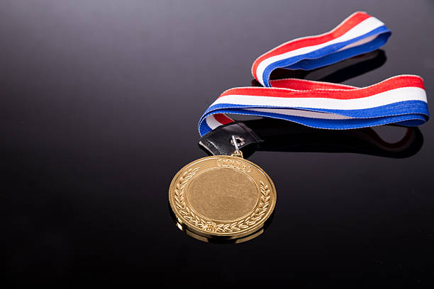 istock Generic sporting event gold medal with red and blue ribbon 540749714