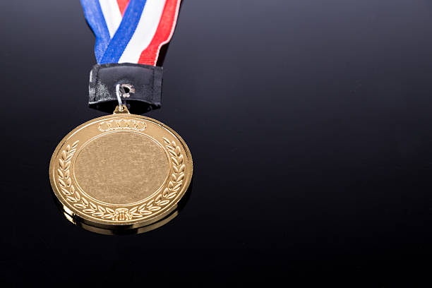 istock Generic sporting event gold medal with red and blue ribbon 540749756
