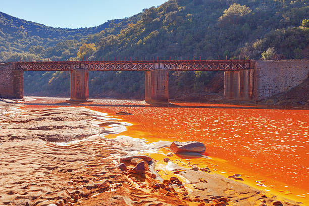 Death and desolation in the Tinto River, Huelva, Spain. As a possible result of the mining, Rio Tinto is notable for being very acidic and its deep reddish hue is due to iron and copper dissolved in the water.