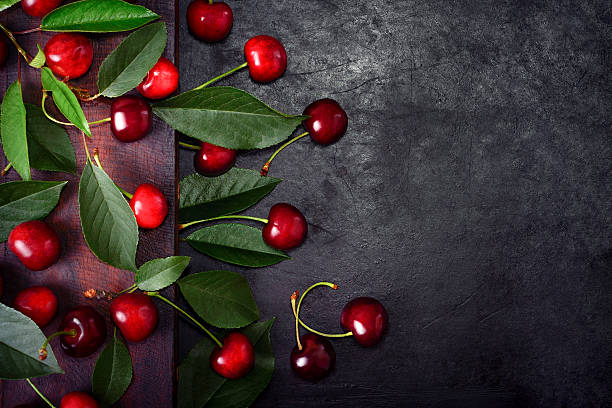 istock sweet cherries with green leaves 540751694