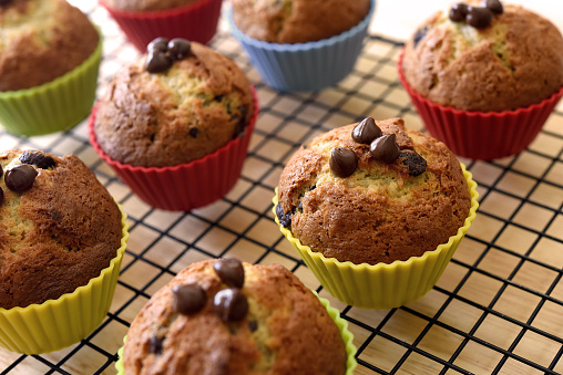 Several banana chocolate muffins in the early morning light.