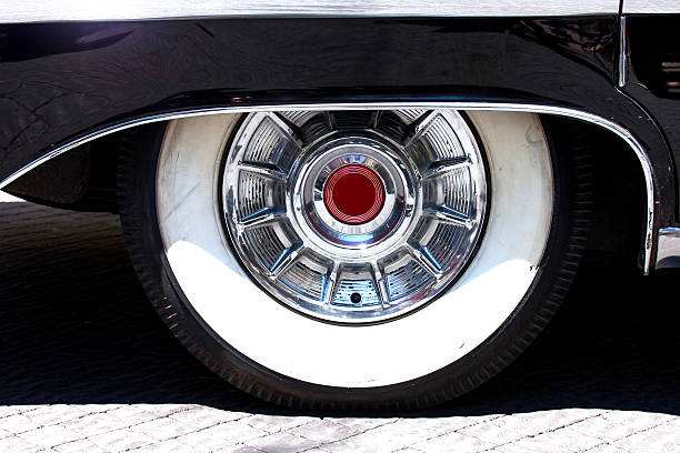 istock Old car wheel covered by black metallic wing 540756224