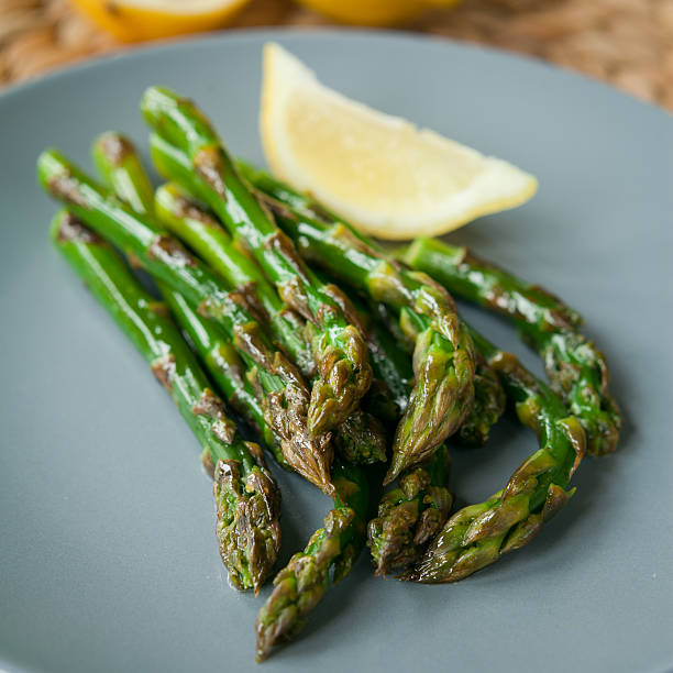 istock Green asparagus with lemon juice. 540758242