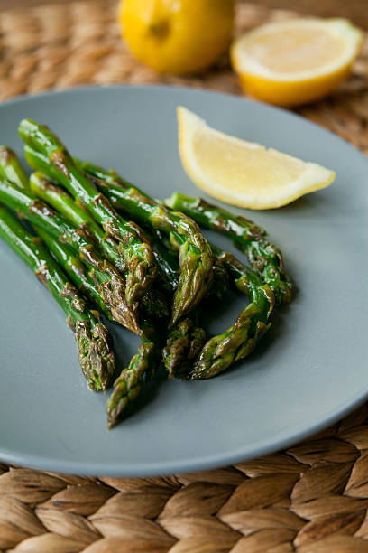 istock Green asparagus with lemon juice. 540758868