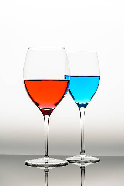 istock two glasses with blue colored water and wine 540761934