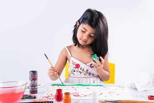 indian girl drawing, indian girl painting, asian girl colouring indian girl drawing, indian girl painting,asian girl colouring, paint brush and indian girl preschool building photos stock pictures, royalty-free photos & images