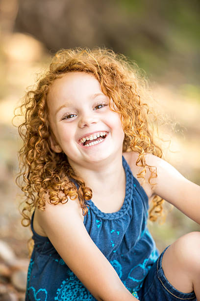 Close-Up of Laughing Young Girl Outdoors stock photo