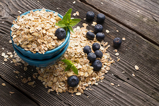istock Blue ceramic bowl full of cereal flakes and fresh berries 540829918