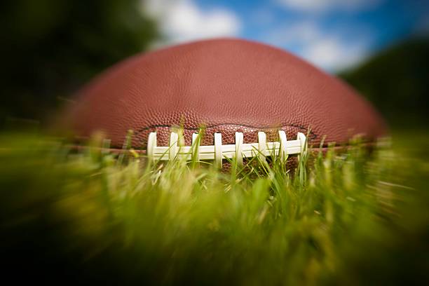istock American football ball on grass 540831502