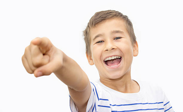 istock Portrait of happy boy pointing somewhere over white background 540832038