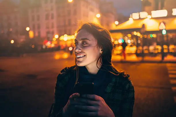 Photo of Woman texting at night