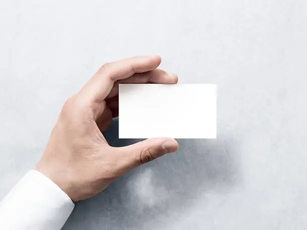 Photo of Hand hold blank plain white business card design mockup.