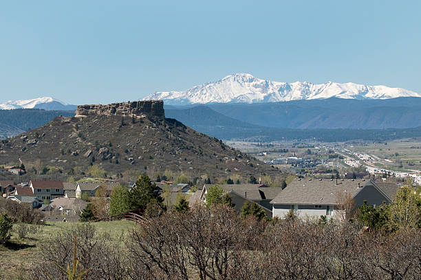 Castle Rock homes Colorado highway snowy Pikes Peak Rocky Mountains Castle Rock mesa and homes stand in front of a snow covered Pikes Peak with Interstate 25 winding its way to the snowy Rocky Mountains, Castle Rock, Colorado.  front range mountain range stock pictures, royalty-free photos & images