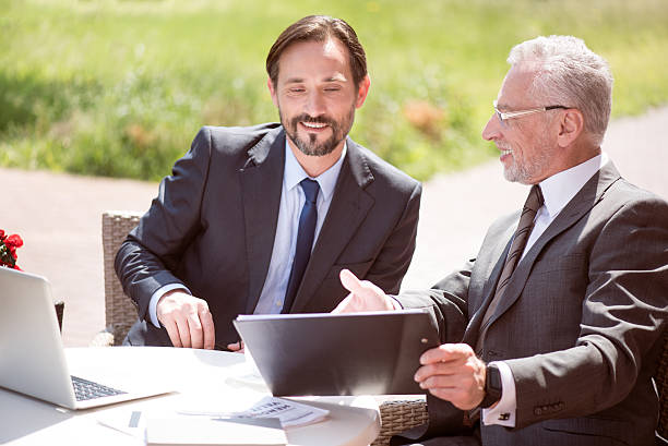 istock Cheerful smiling colleagues sitting at the table 540833854