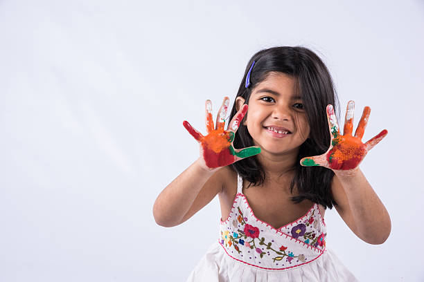 small indian girl and colourful palm painting or palm printing - facial expression child asia asian and indian ethnicities imagens e fotografias de stock