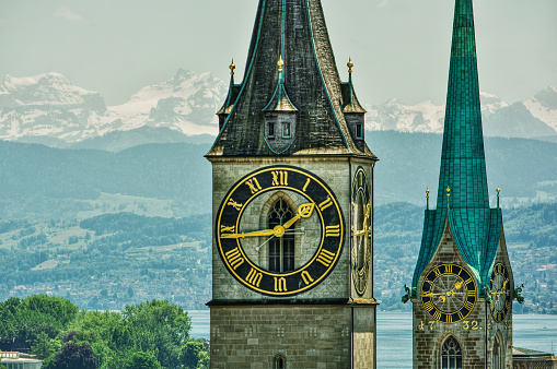 June 2016, Saint Peter and Fraumünster Church in Zurich (Switzerland) in front of lake Zurich and the Swiss Alps, HDR-technique