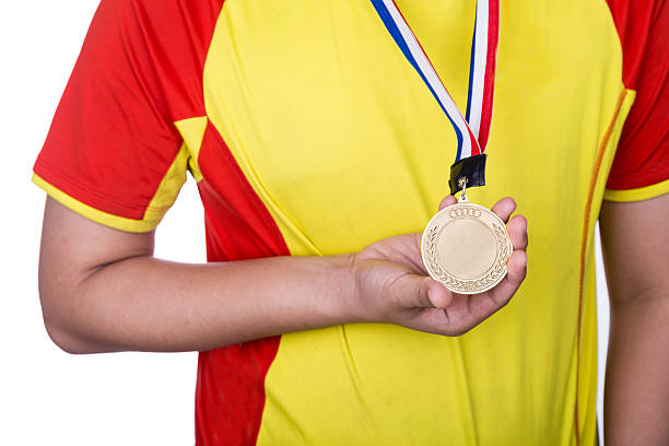 istock Athlete wearing generic gold medal with ribbon on his neck 540836920