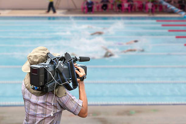 istock Video cameraman operator with competition swim pool in swimming 540837600