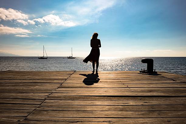 A woman standing on the pier 