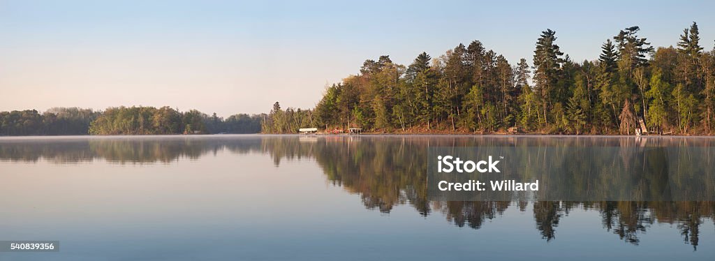 Panorama of Minnesota Lakeshore on Calm Morning During Spring A panorama of a typical northern Minnesota lakeshore on a calm morning during Spring Minnesota Stock Photo