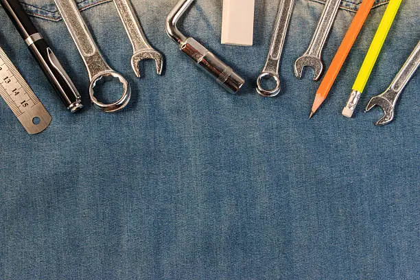 Photo of Wrench tools on a denim. Labour Day.