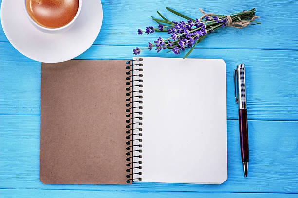 istock blank white notebook, bunch of lavender and cup of coffee 540842260