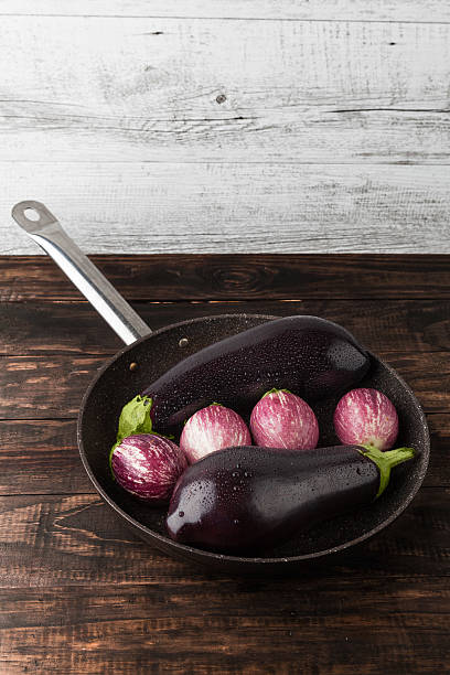 istock Wet eggplants in frying pan vertical image with copy space 540844540