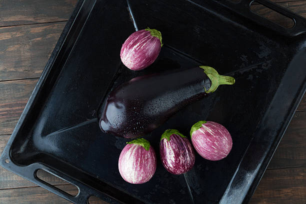 wet eggplants in frying pan top view