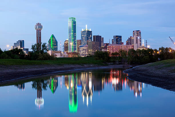 Dallas Downtown Skyline at night Dallas downtown skyline illuminated at night with reflection in the Trinity River. Texas, United States reunion tower photos stock pictures, royalty-free photos & images