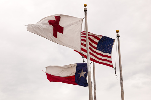 Dallas, Tx, USA - April 9, 2016: Flags of the USA, State of Texas and Red Cross waving in the wind