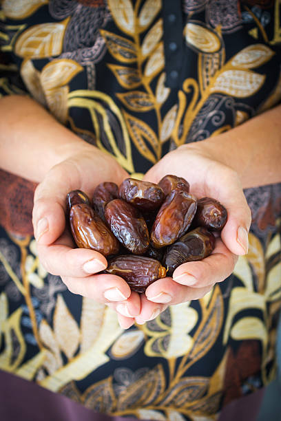istock Woman's hand holding dried date fruit. 540847618