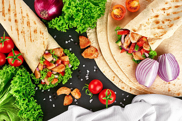 Burrito with grilled chicken and vegetables Burrito with grilled chicken and vegetables (fajitas, pita bread, shawarma) shawarma stock pictures, royalty-free photos & images