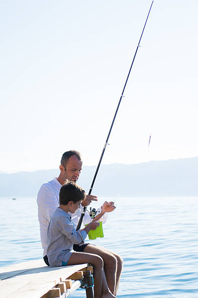 istock Father and son fishing 540849296